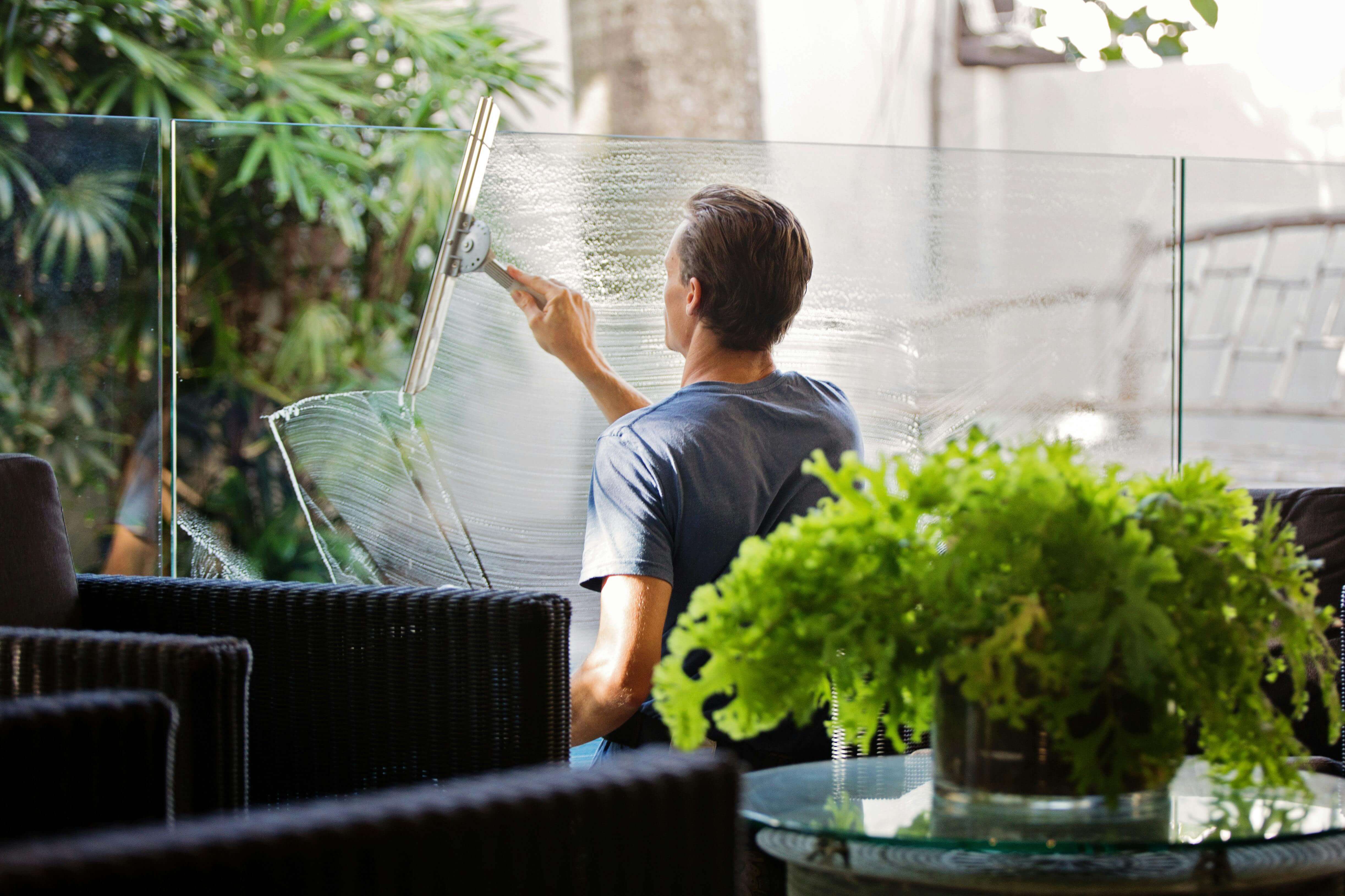 Picture of a man cleaning a window